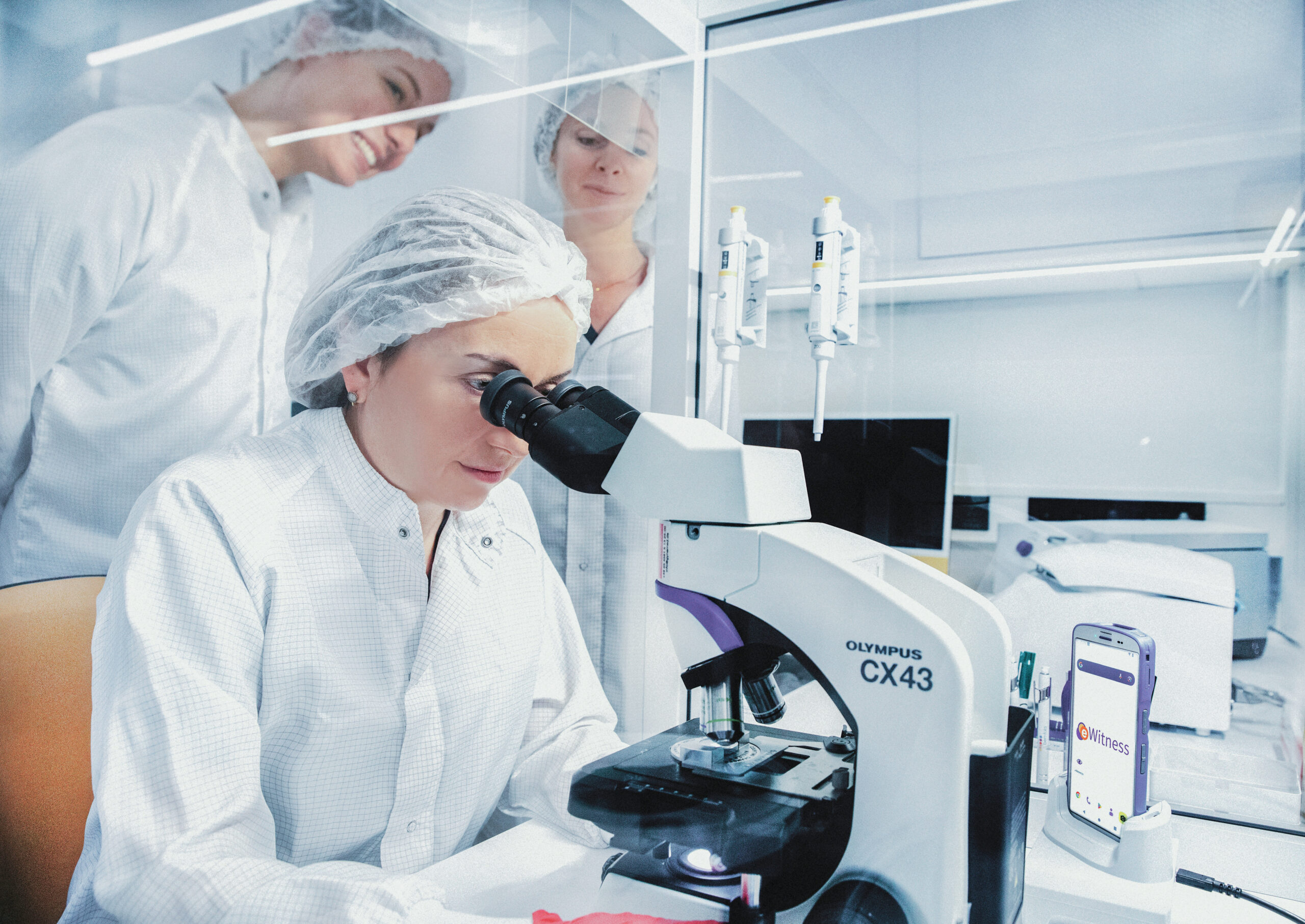 Embryology team in the IVF laboratory working on samples with protective clothing.